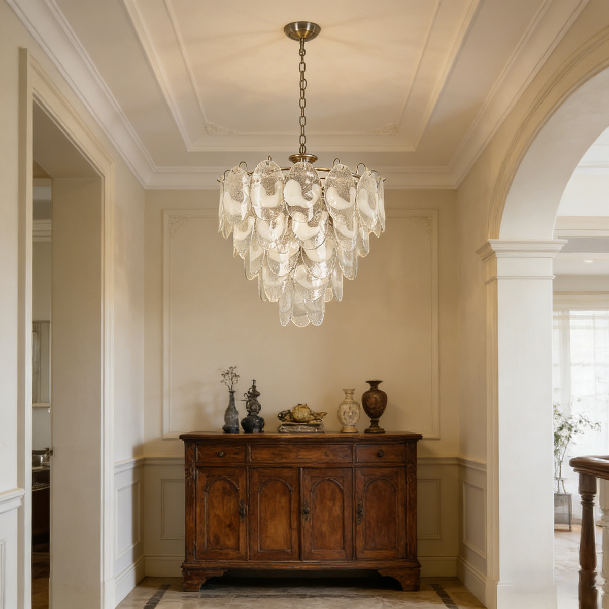 Lit Mazzega-style white glass chandelier, showing warm light filtering through the textured glass discs.