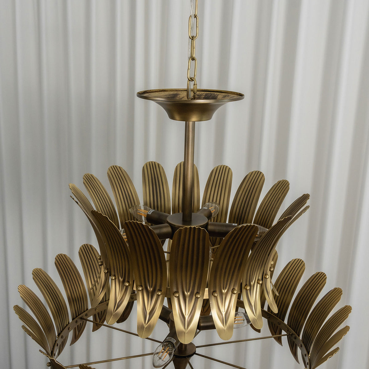 Side view of the vintage brass leaf chandelier, highlighting its depth and tiered leaf design.