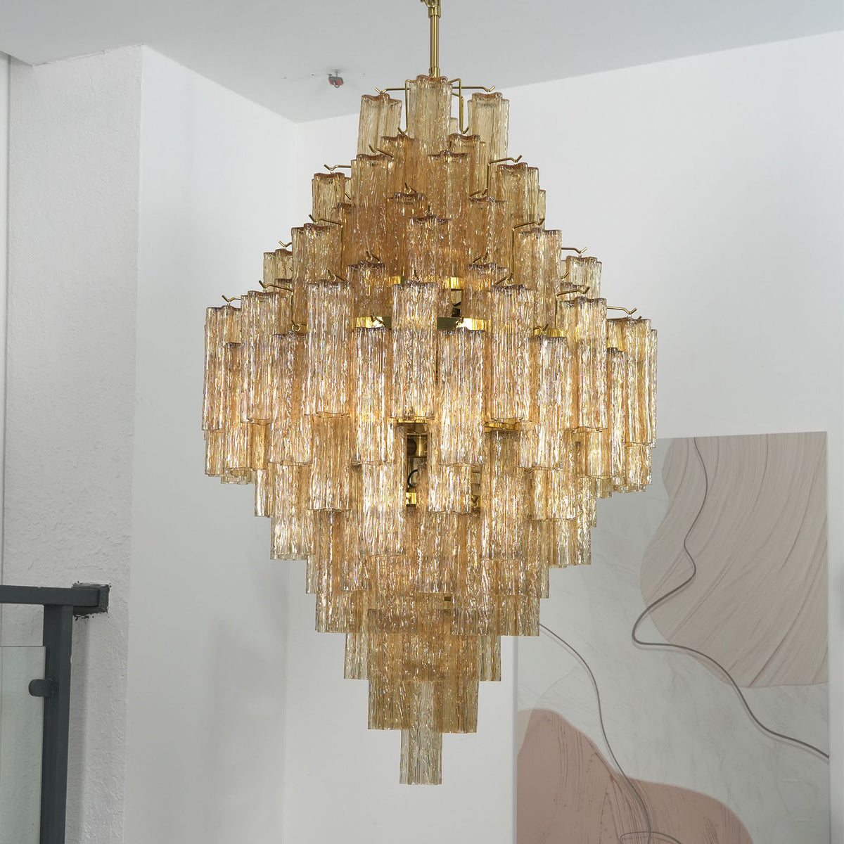 Close-up of the gold metal frame and glass tube holders on the Addis Diamond Chandelier