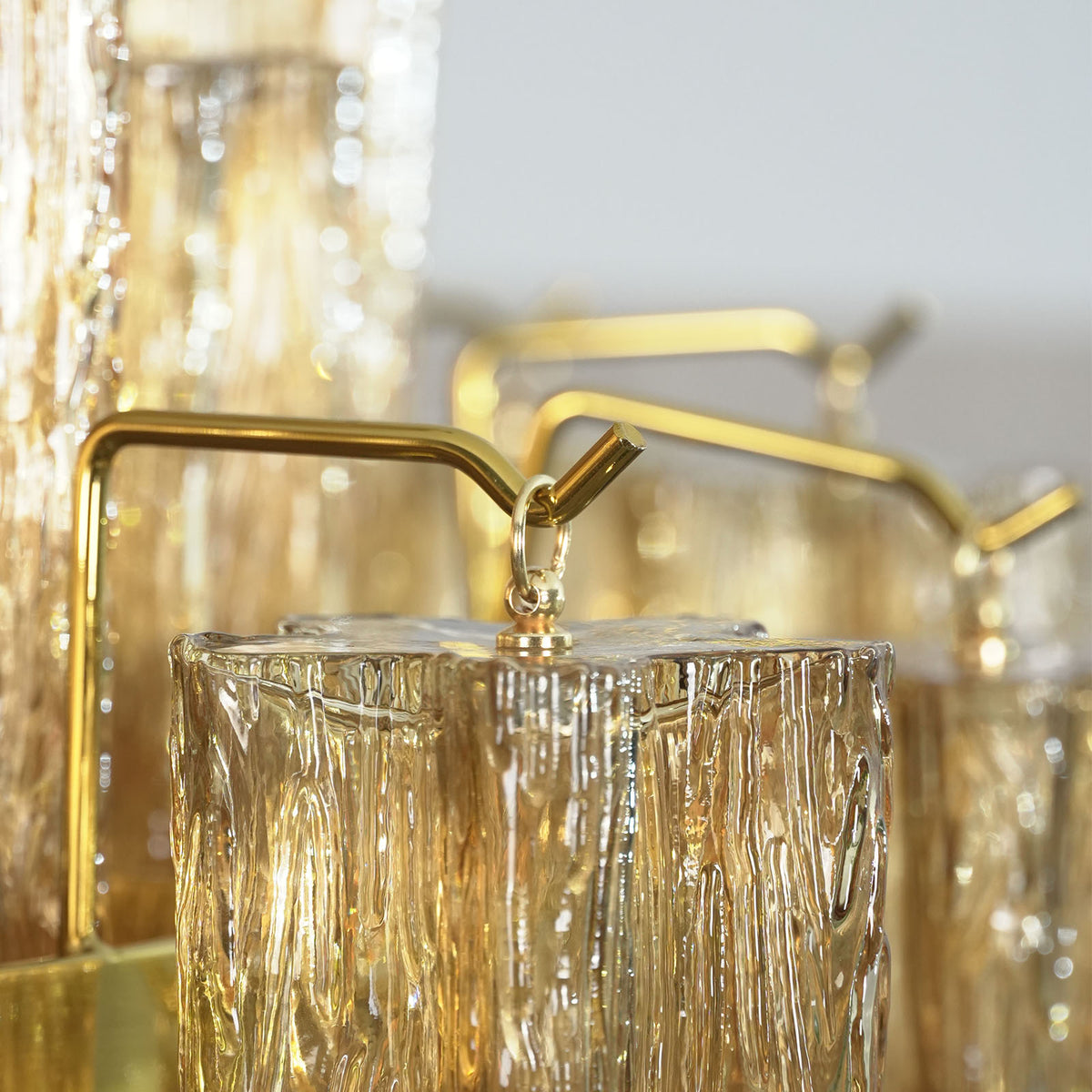 Close-up of the full multi-tiered structure of the Addis Diamond Chandelier with amber glass