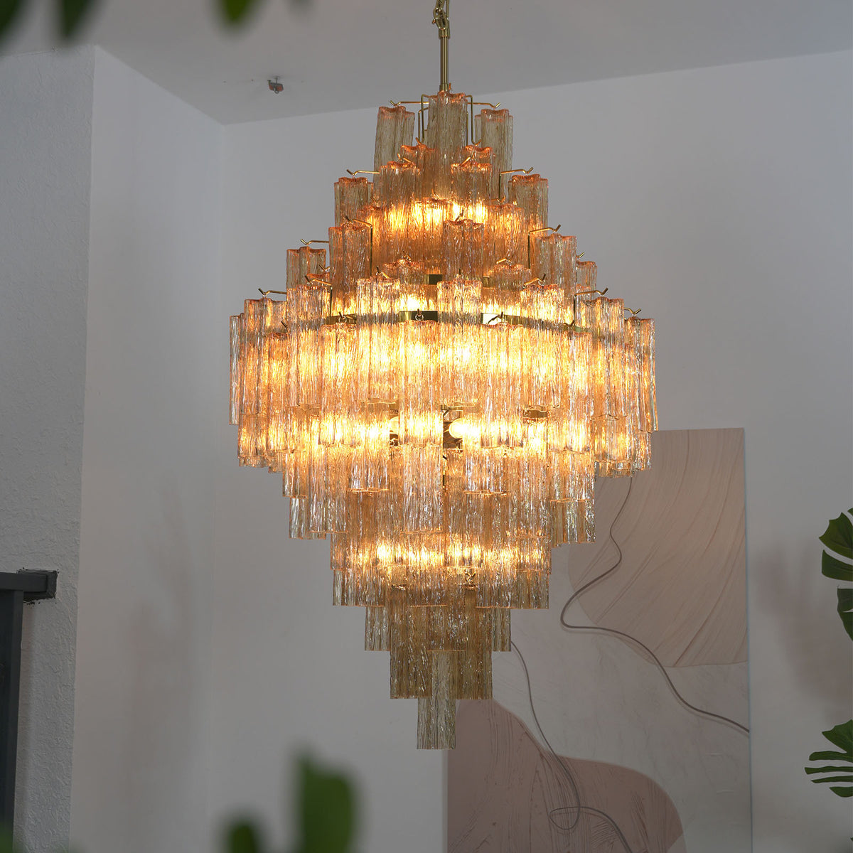 Addis Diamond Chandelier with glowing amber glass, showing the multi-tiered design