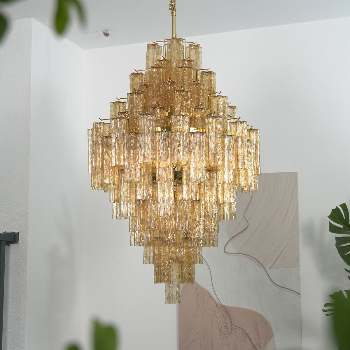 Addis Diamond Chandelier with amber glass hanging in a modern living room