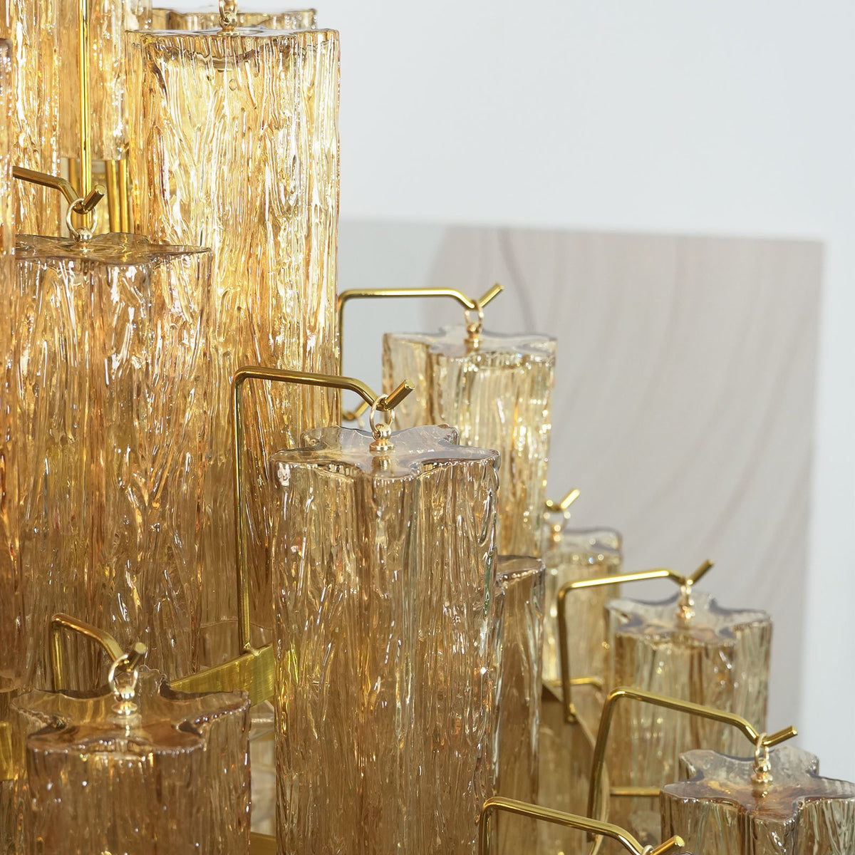 Addis Diamond Chandelier with amber glass, side view with arched window in background