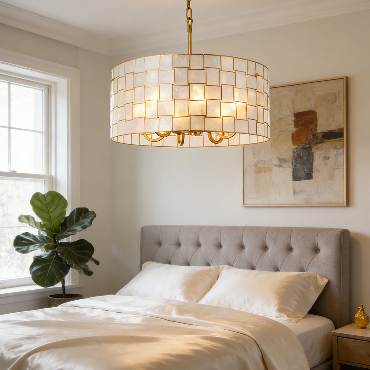 Capiz Shell Drum Chandelier over a tufted bed in a bright bedroom Metavaya