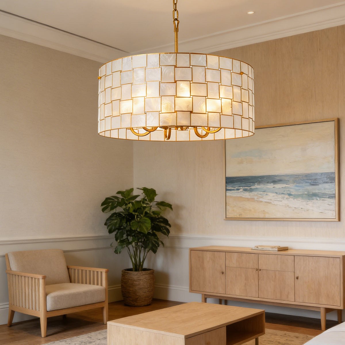 Capiz Shell Drum Chandelier hanging in a light wood modern living room with warm light Metavaya