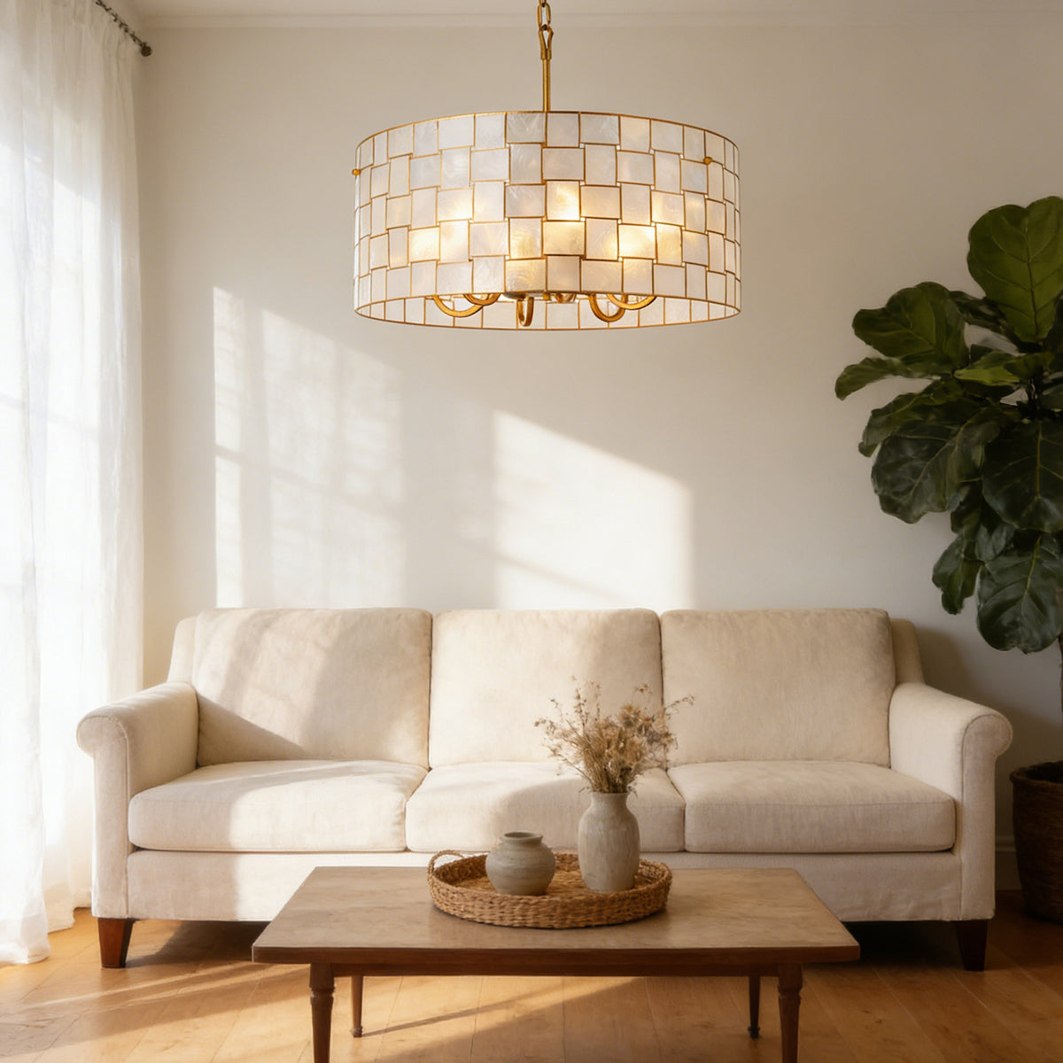 Capiz Shell Drum Chandelier hanging in a sunlit cozy living room with soft shadows Metavaya