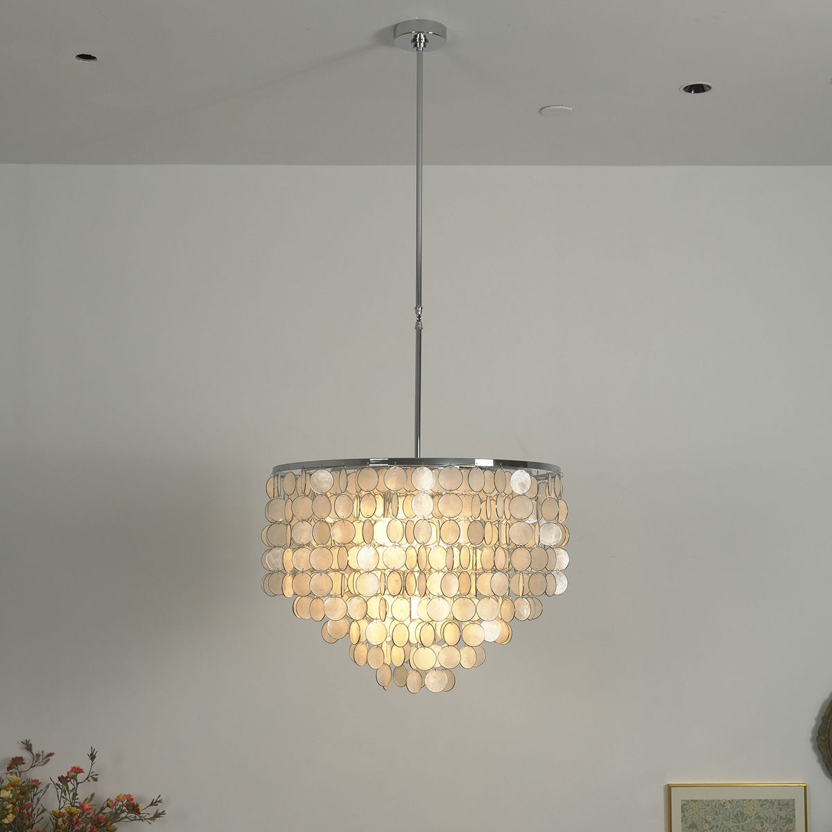 Close-up of the polished metal ring and hanging hardware on the capiz shell chandelier.