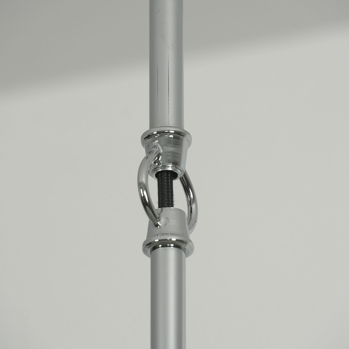 Close-up of the adjustable connector on the hanging pole of the capiz shell round chandelier.