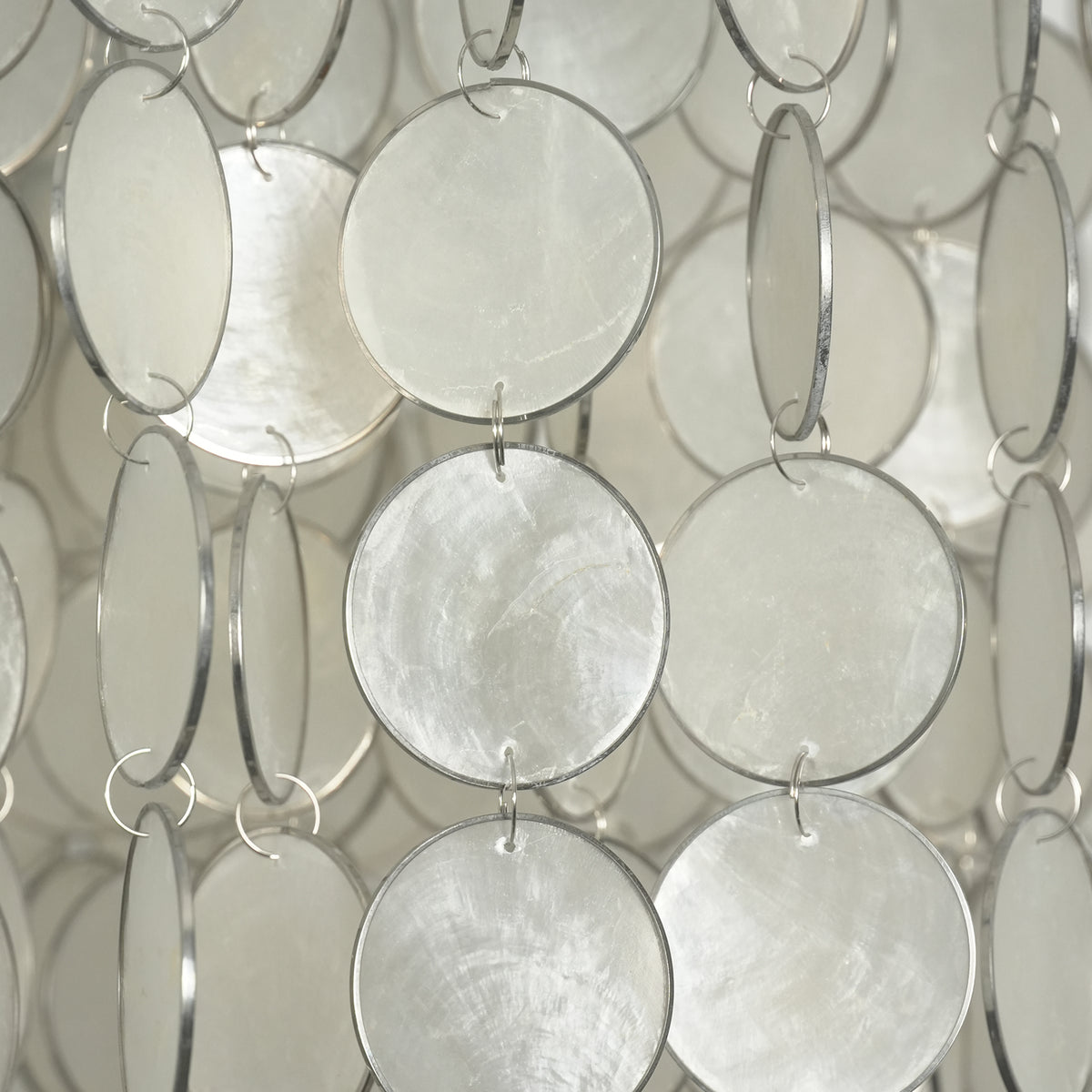 Close-up of the adjustable hanging pole and connector on the capiz shell round chandelier.