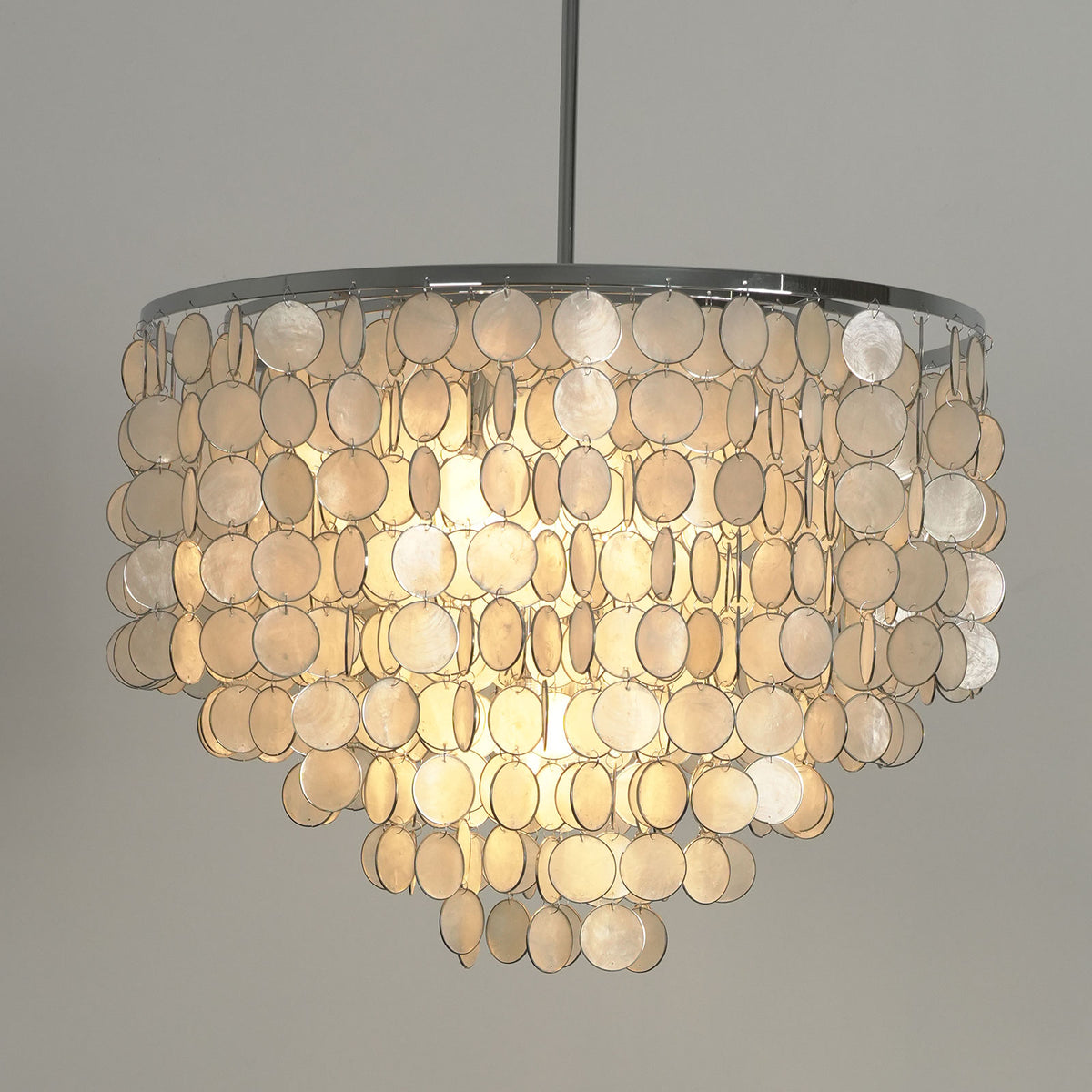 Close-up of the natural texture and iridescent finish of the capiz shell discs on the chandelier.