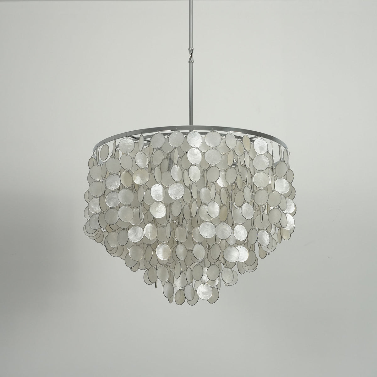 Side view of a capiz shell round chandelier showing its layered shell disc structure.