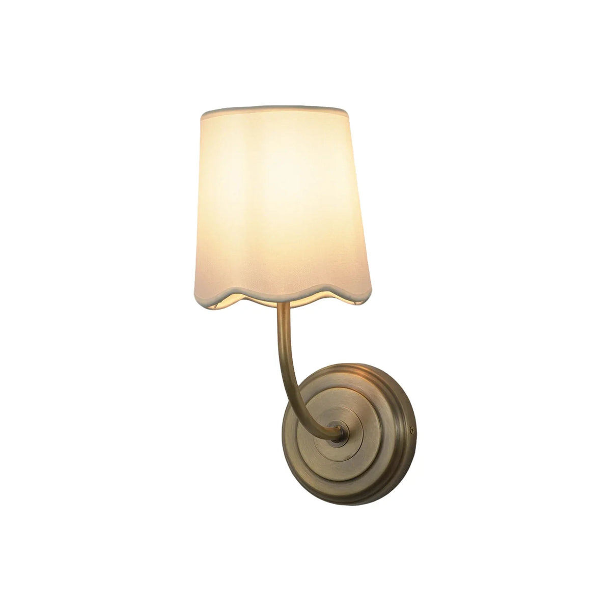 Curved Arm Fabric Shade Wall Sconce with antique brass finish and cream shade, on white background
