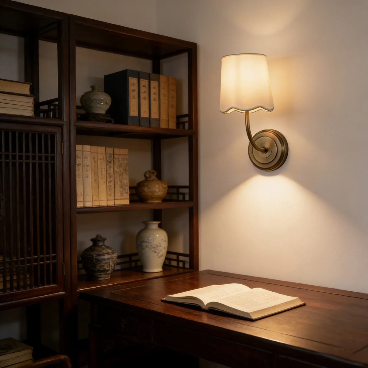 Lit Curved Arm Fabric Wall Sconce above a wooden desk in a home office