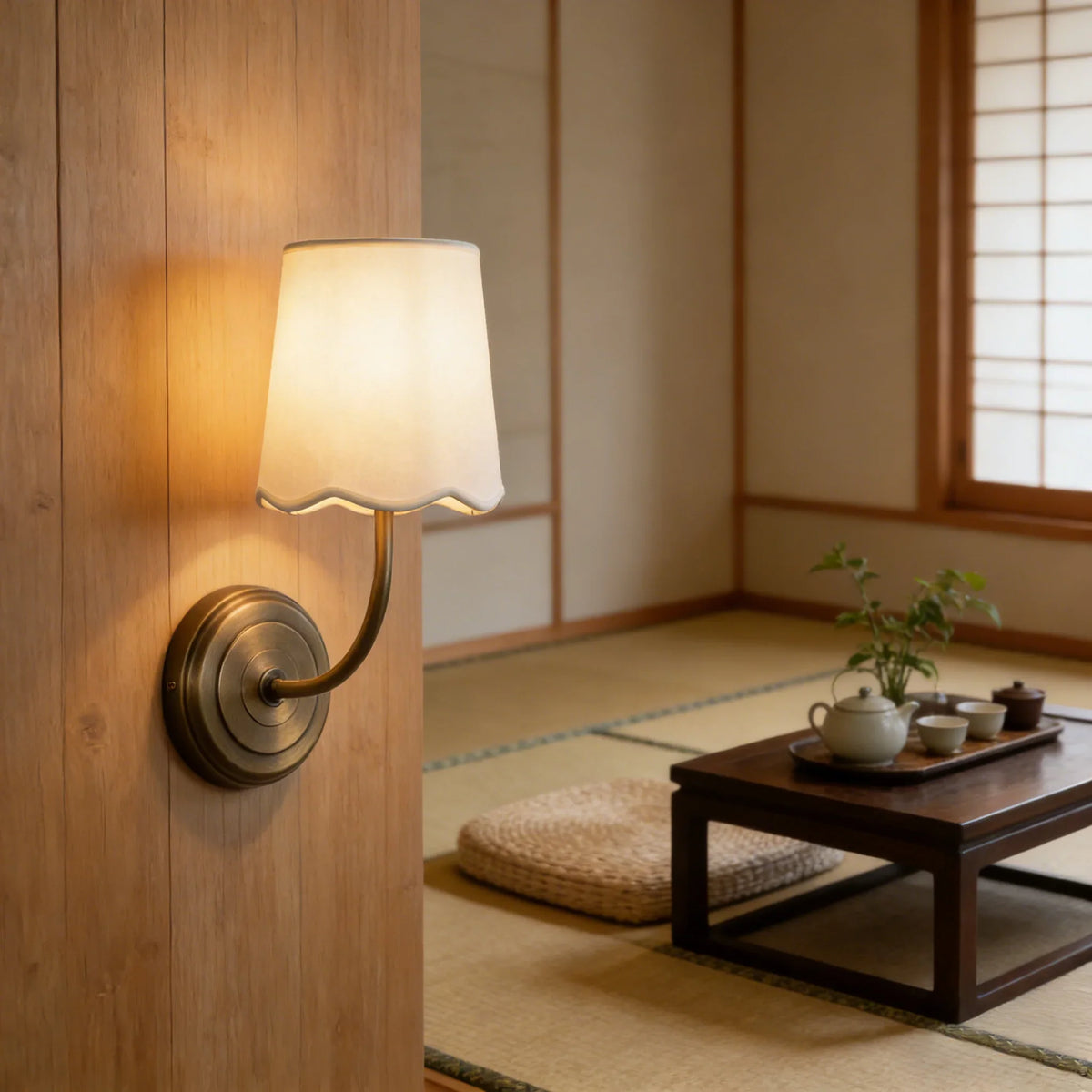 Lit Curved Arm Fabric Wall Sconce mounted on a light wood panel wall in a tatami room
