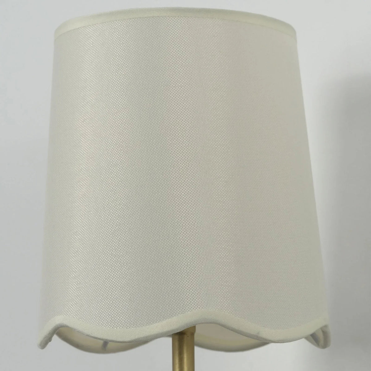 Close-up of the cream fabric shade texture on the Curved Arm Wall Sconce