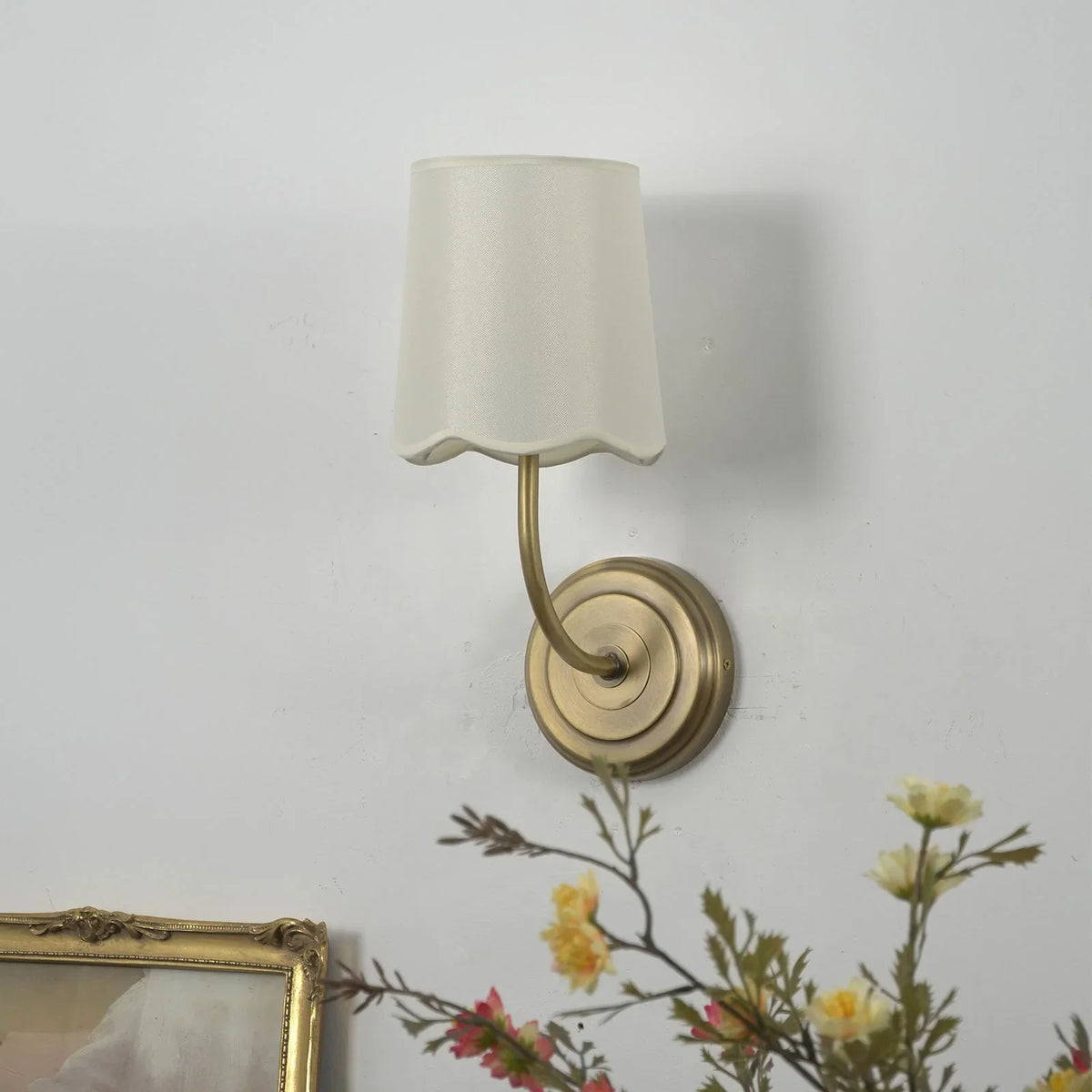 Unlit Curved Arm Fabric Wall Sconce with cream shade and floral decor