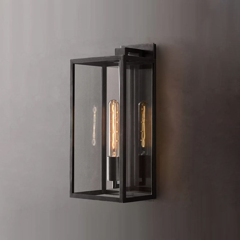Close-up of the brass metal frame and clear glass on the Faraday wall sconce.