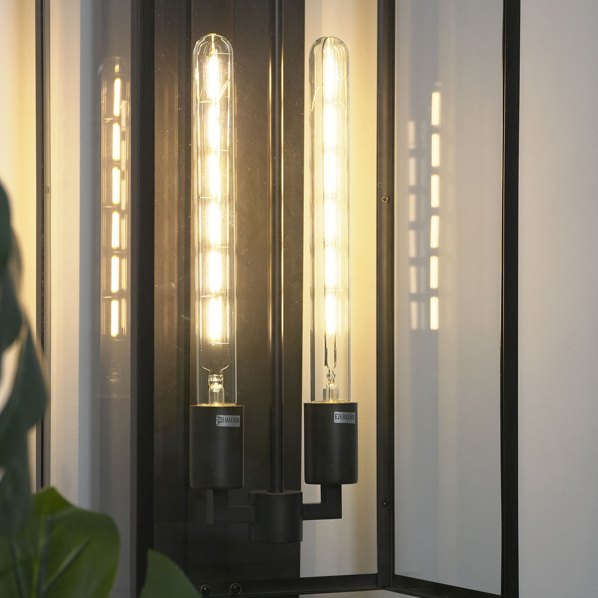 Brass/gold variant of the Faraday wall sconce mounted on a neutral-toned wall.