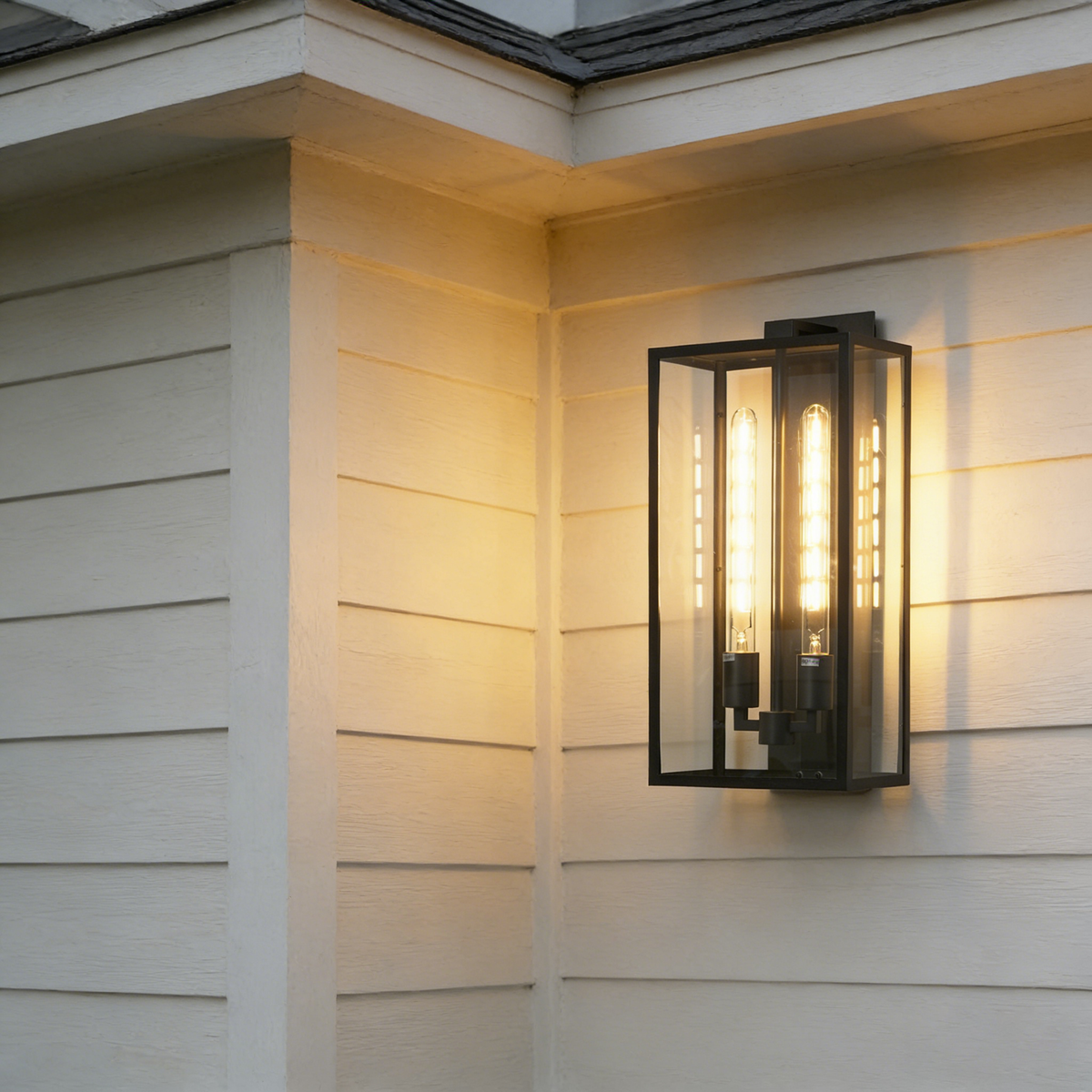 Faraday outdoor wall sconce mounted on the corner of a light-colored house siding.