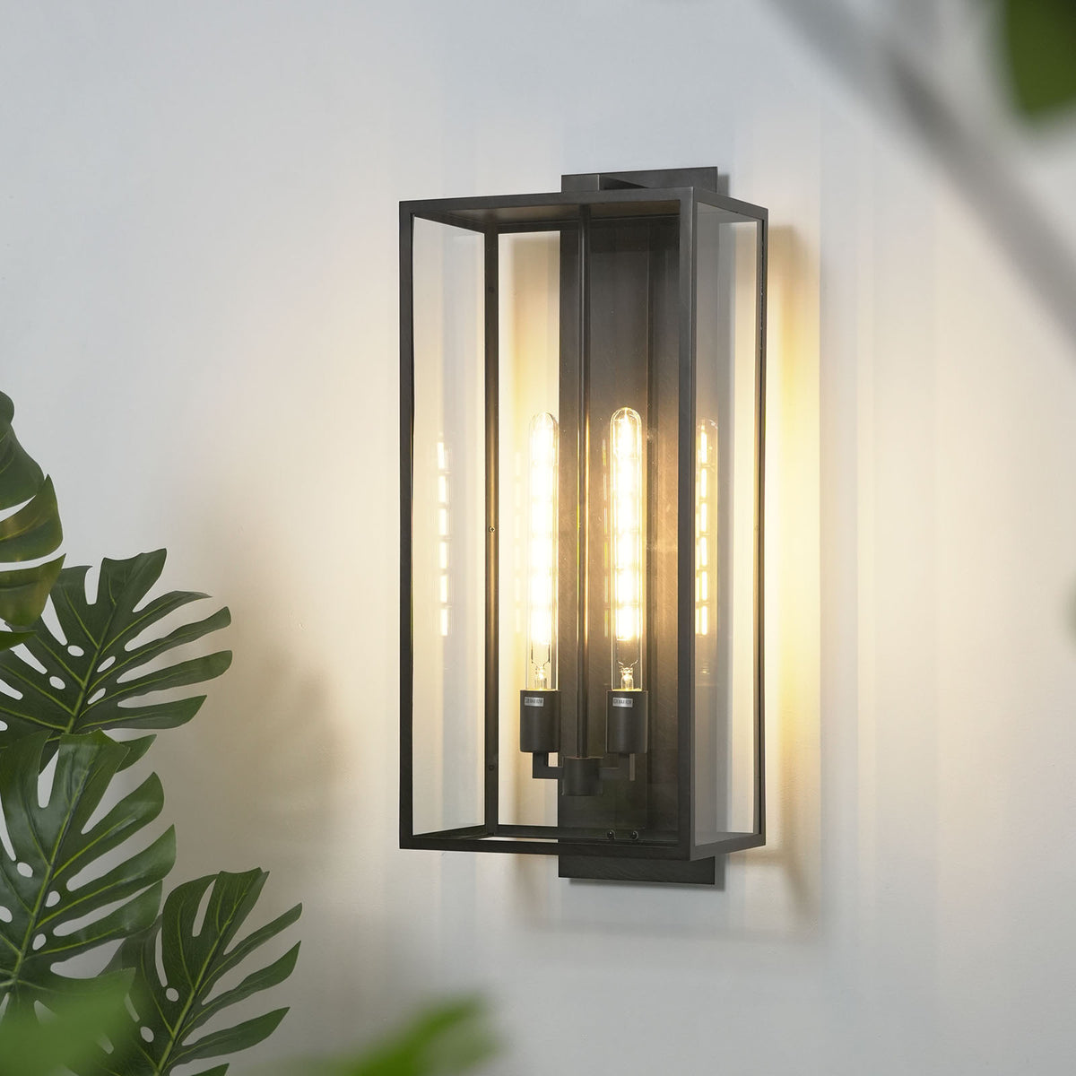 Side view close-up of the Faraday outdoor wall sconce, showing its profile and mounting hardware.