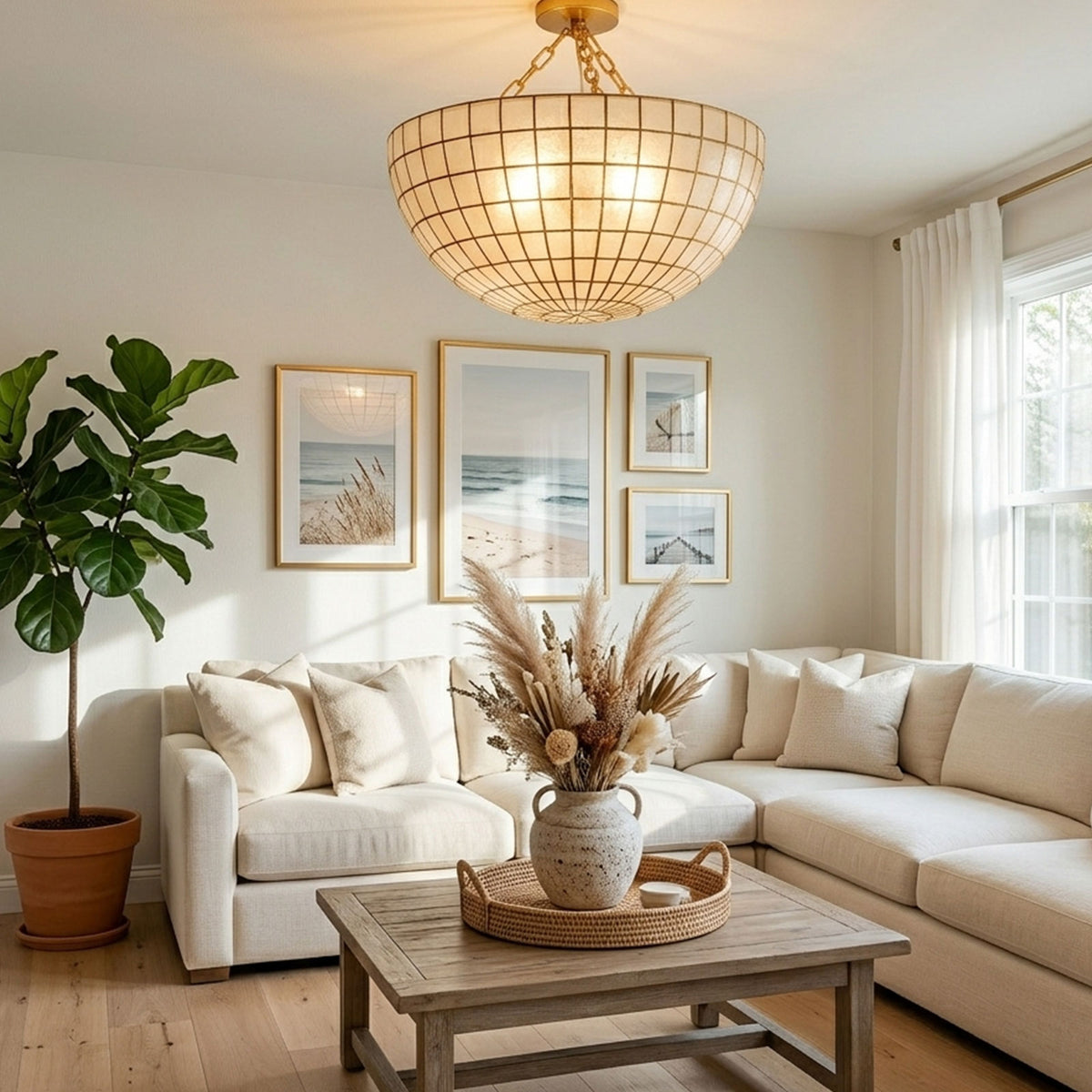 Gold grid capiz shell ceiling light hanging in a bright white living room with gallery wall decor Metavaya