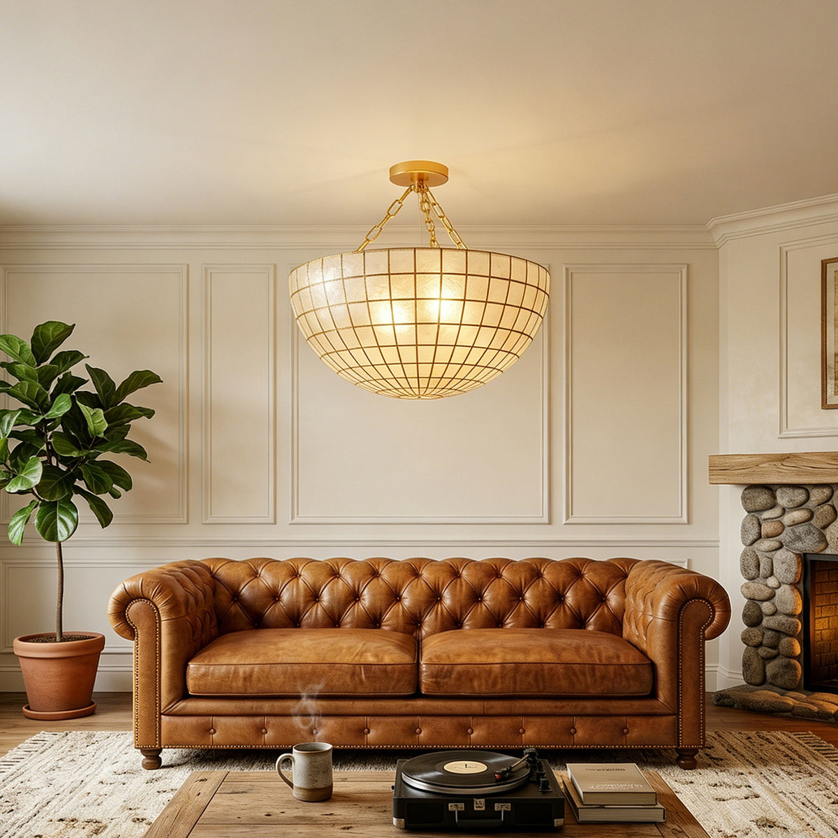 Gold grid capiz shell ceiling light in a warm-toned living room with tufted leather sofa Metavaya