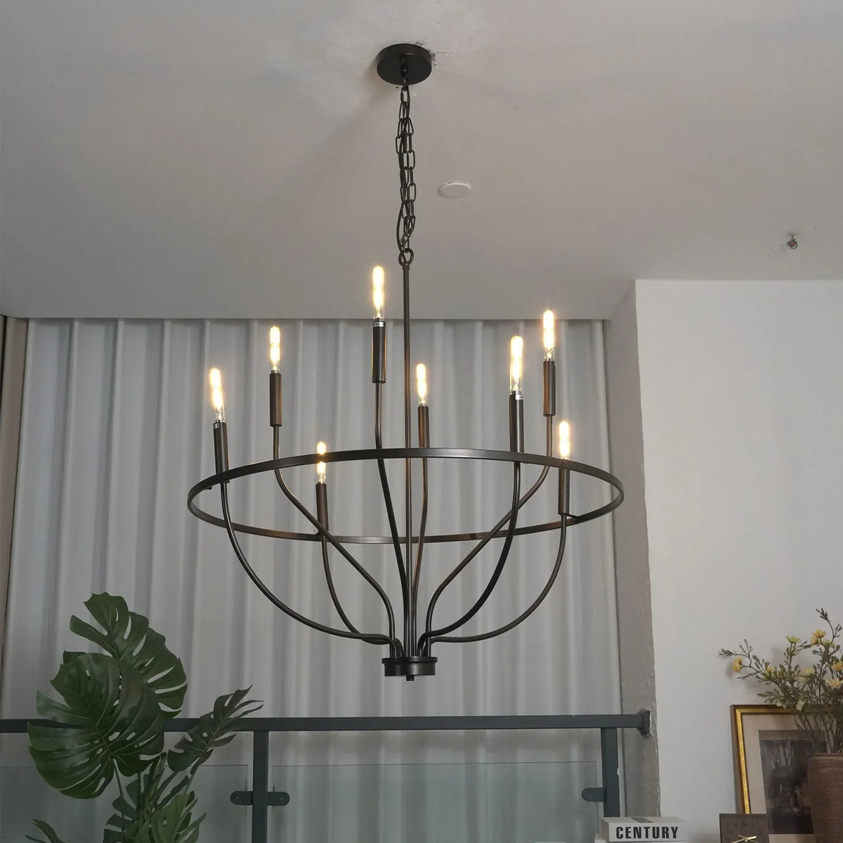 Greyson Bowl Chandelier side view in a minimalist room with framed art