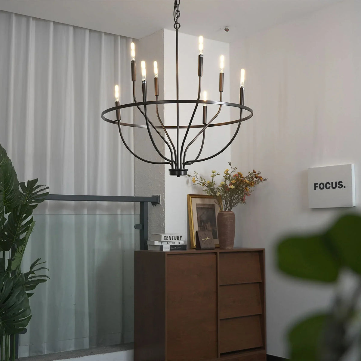 Greyson Bowl Chandelier in a bright corner with sheer curtains and plants
