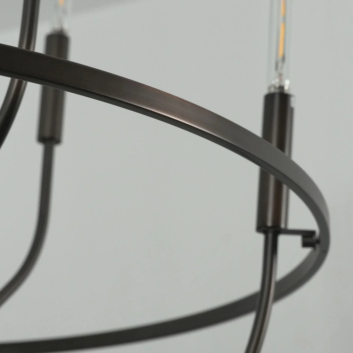 Close-up of the dark bronze metal frame and candle holders on the chandelier
