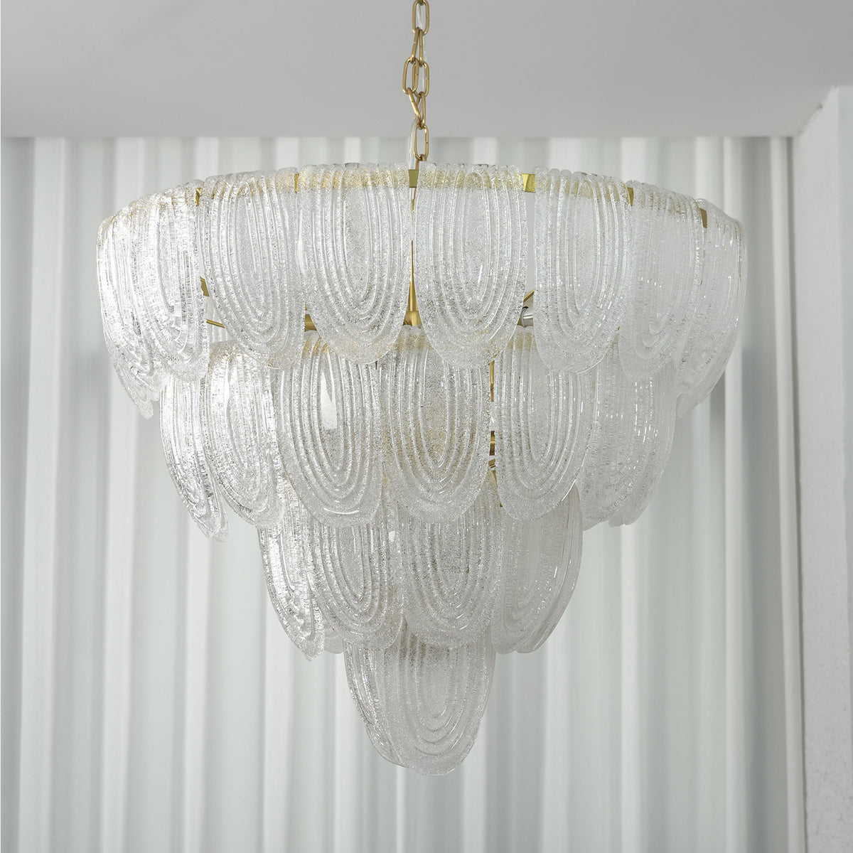Close-up of the cascading arrangement of glass petals on the layered chandelier.