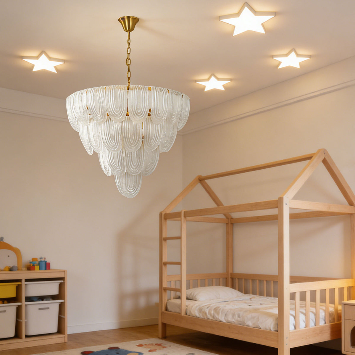 Layered glass petal chandelier hanging in a playful kids' bedroom with a wooden bunk bed and star ceiling lights.
