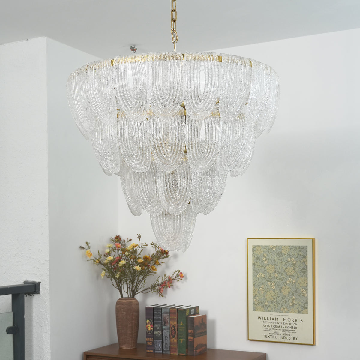 Lit layered glass petal chandelier, showing warm light filtering through the textured glass petals.