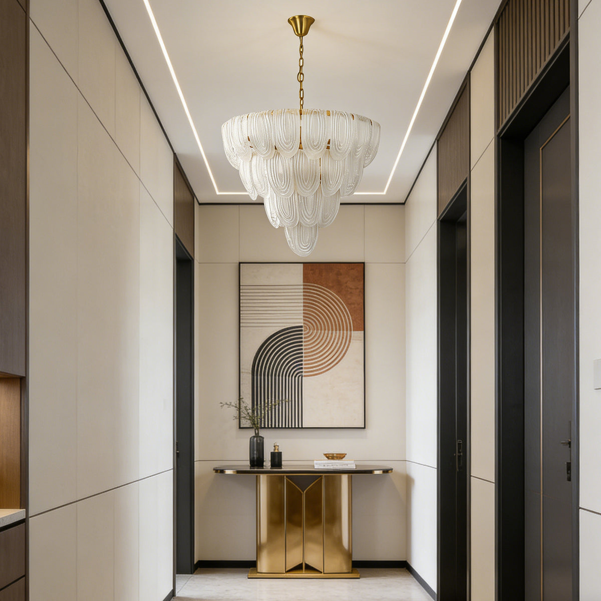 Layered glass petal chandelier in a minimalist entryway with a gold console table and abstract wall art.