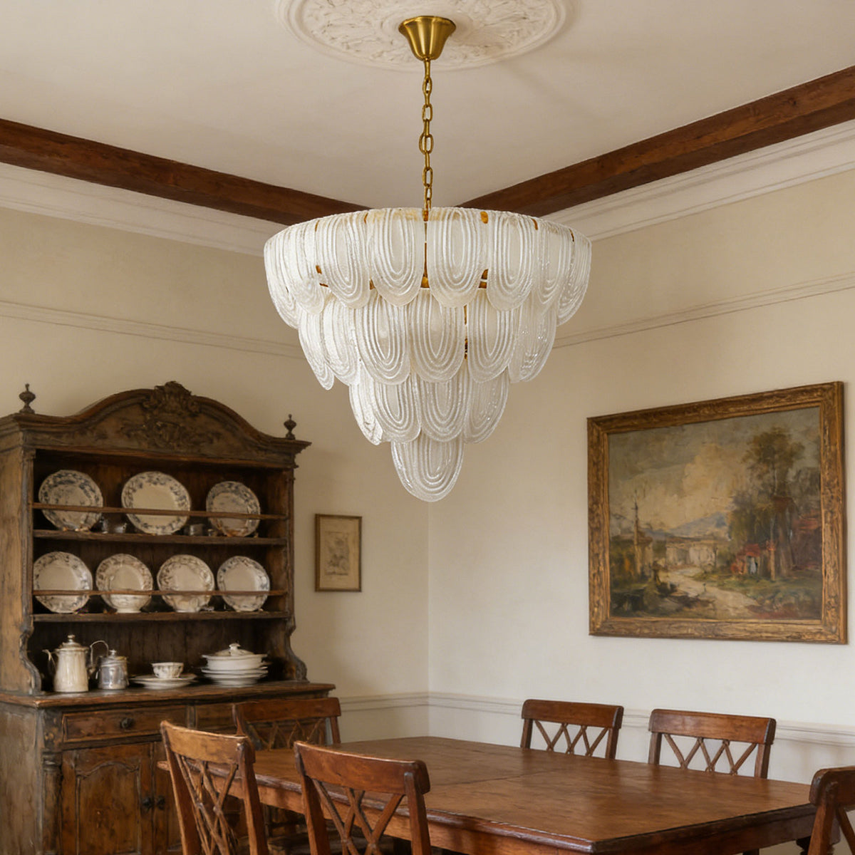 Layered glass petal chandelier hanging above a wooden dining table in a traditional dining room with a china cabinet.