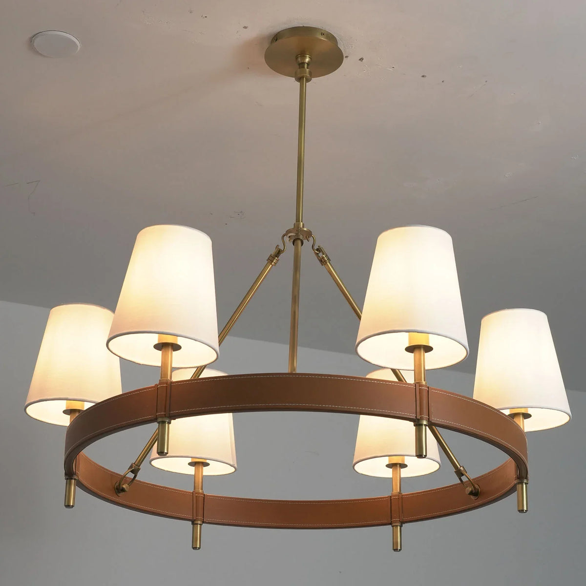 Angled view of the round Leather Halo Ring Chandelier showing the leather ring and shades