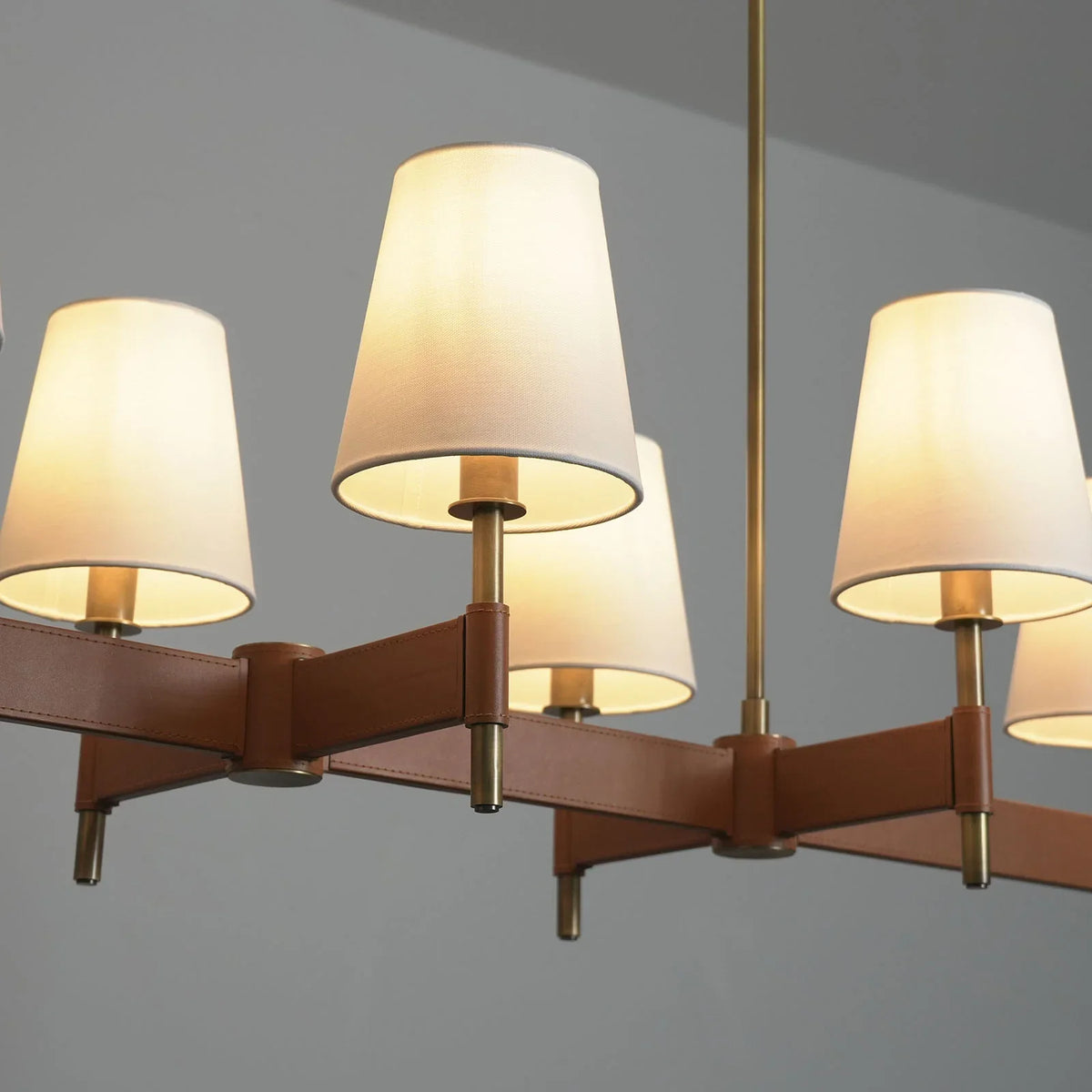 Angled view close-up of the Leather Halo Ring Chandelier showing fabric shades and leather ring