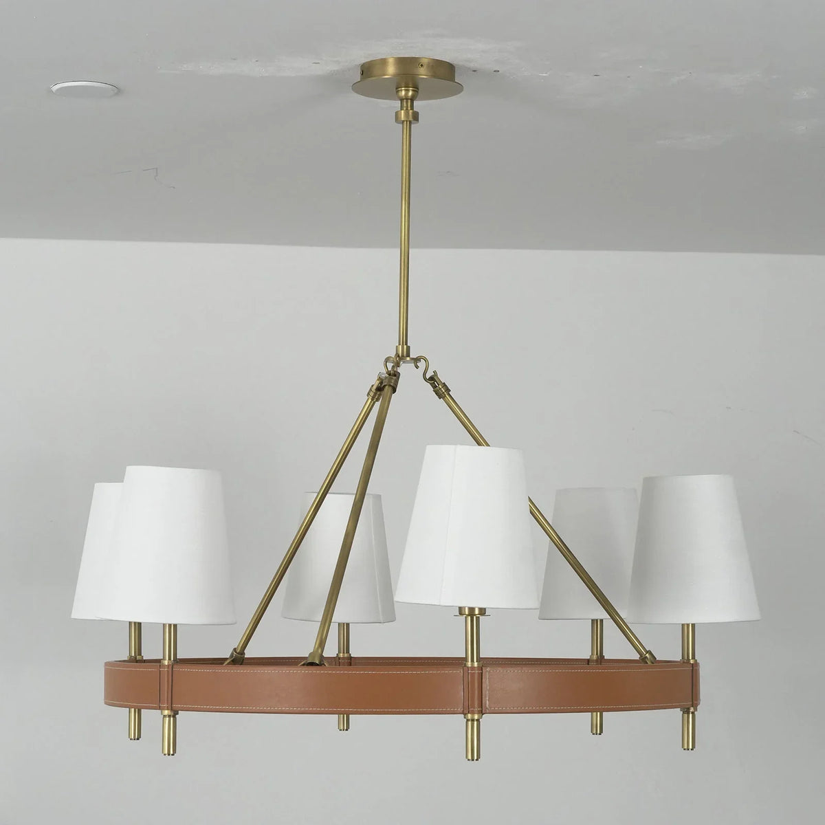 Close-up of the brass hardware and hanging chain on the Leather Halo Chandelier