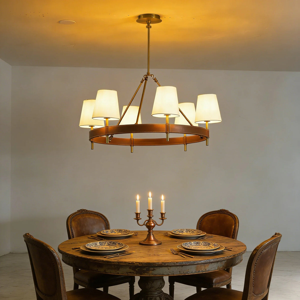 Leather Halo Ring Chandelier above a round dining table with wooden chairs