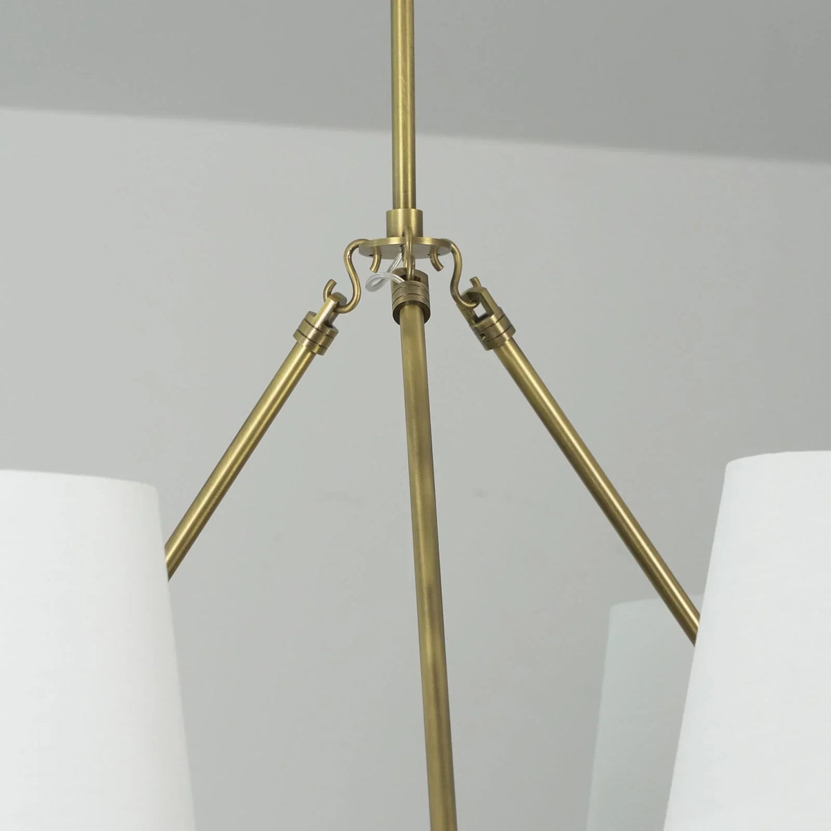 Leather Halo Ring Chandelier above a dining table with a grey sofa in background