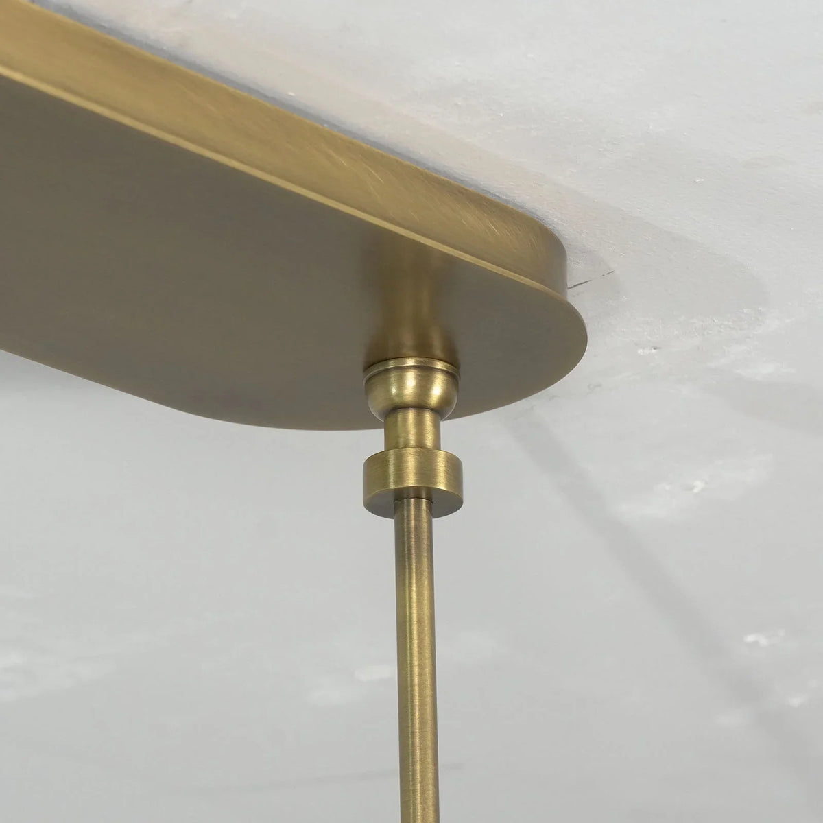 Close-up of the brown leather ring with white stitching on the chandelier