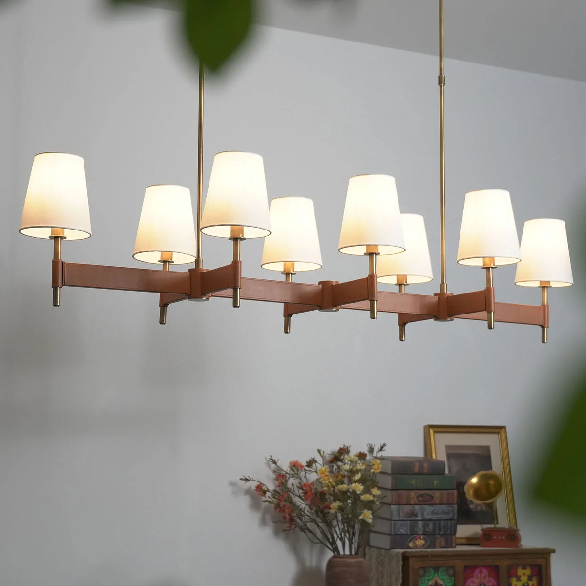 Linear Leather Halo Ring Chandelier in a minimalist corner with floral decor