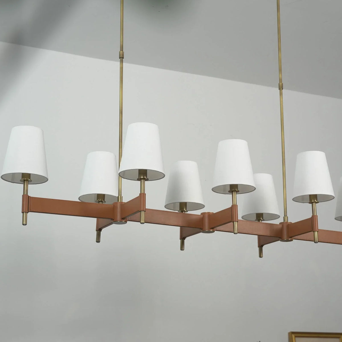 Front view of the linear Leather Halo Ring Chandelier with multiple fabric shades