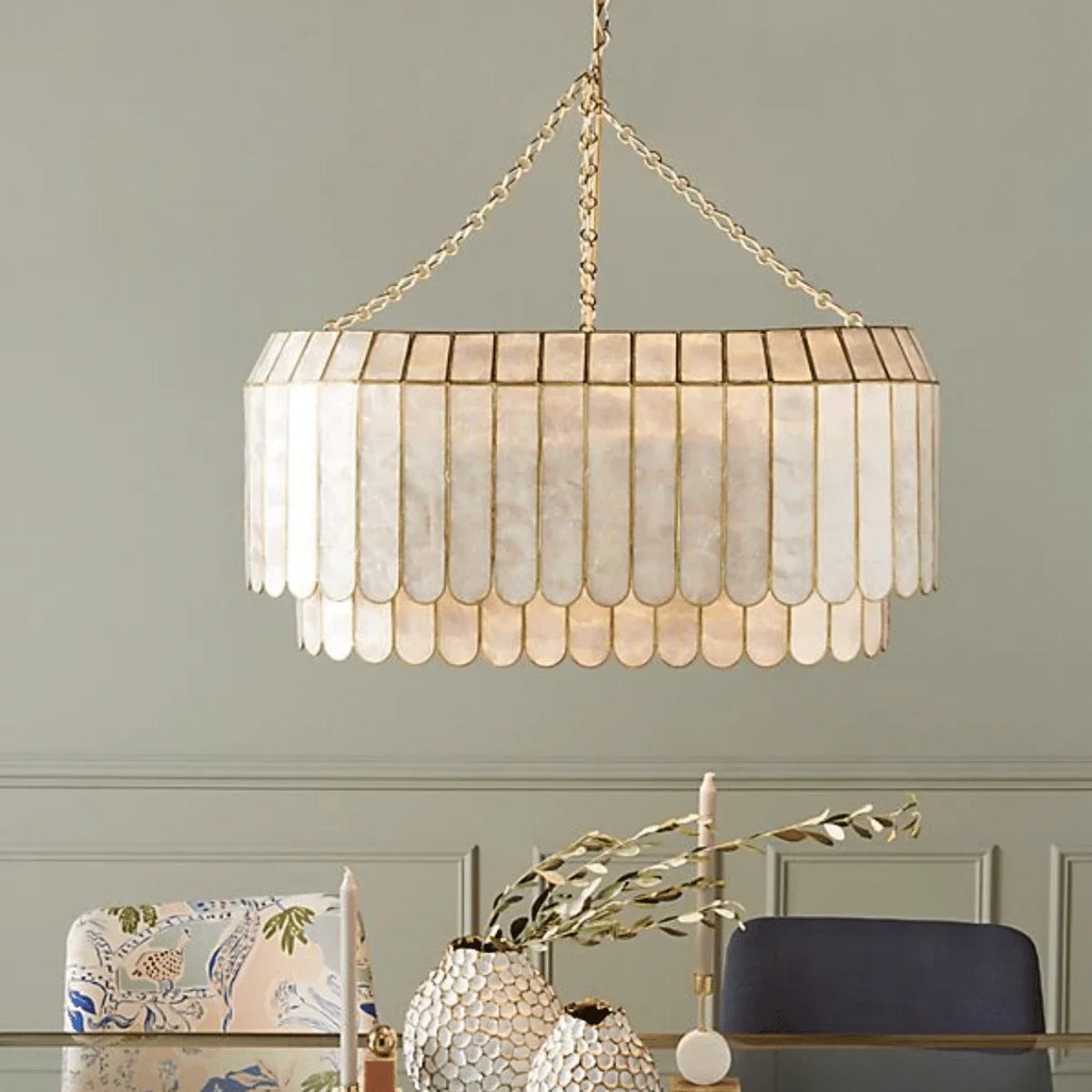 Light Luxury Shell Chandelier hanging above a dining table with neutral decor