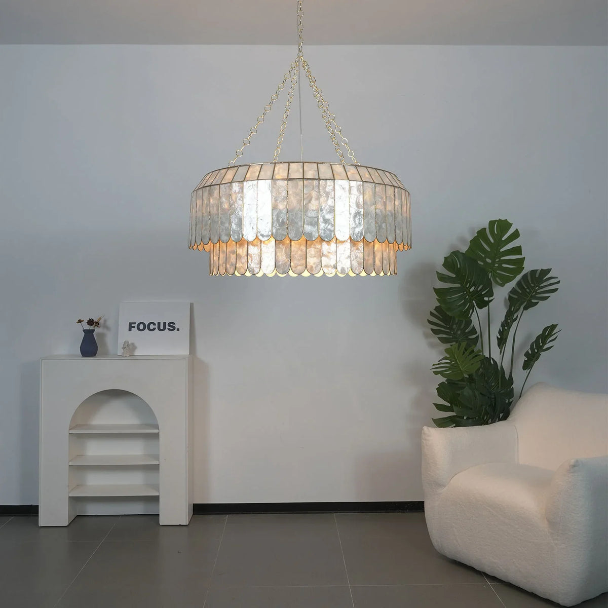 Light Luxury Shell Chandelier double-tier design in a bright white room with plants
