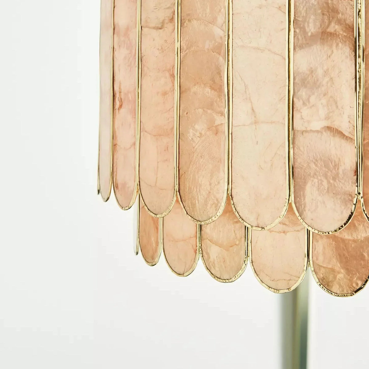 Side view close-up of the gold metal frame and capiz shell panels on the chandelier