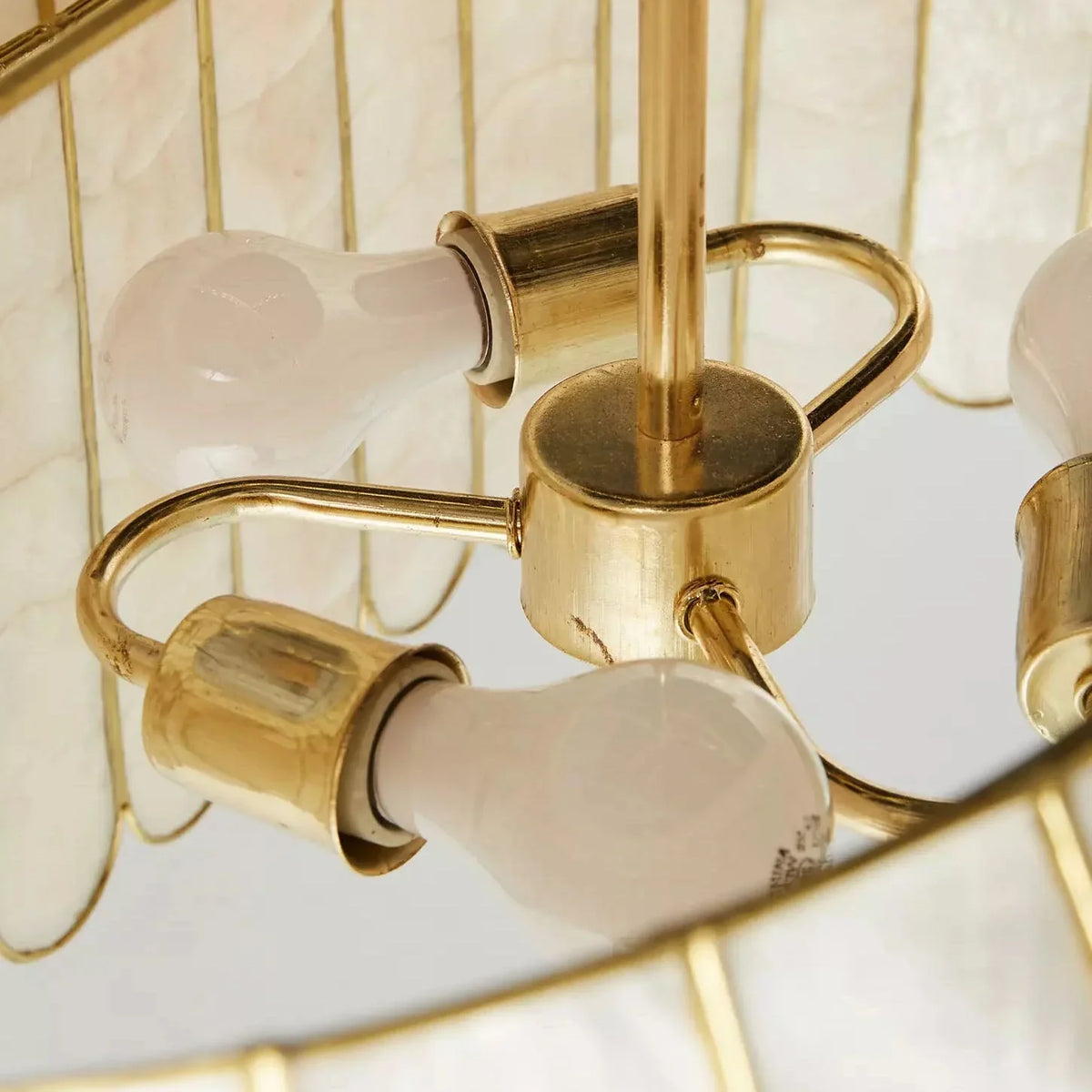 Side view close-up of the capiz shell panels and gold trim on the chandelier