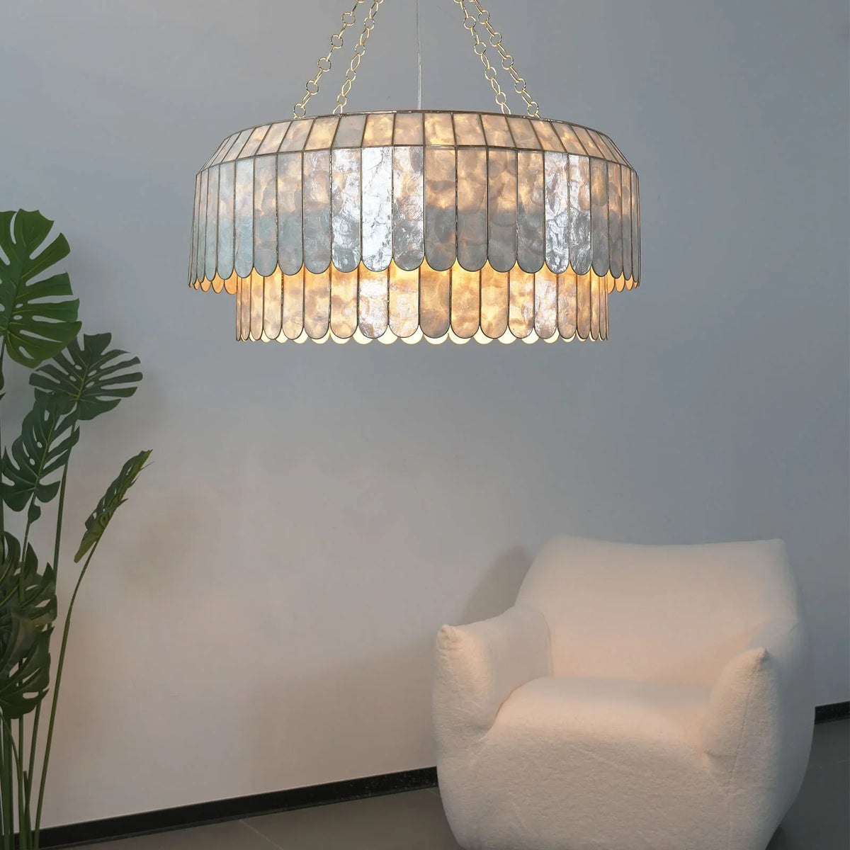 Light Luxury Shell Chandelier side view in a bright white room with tropical plants