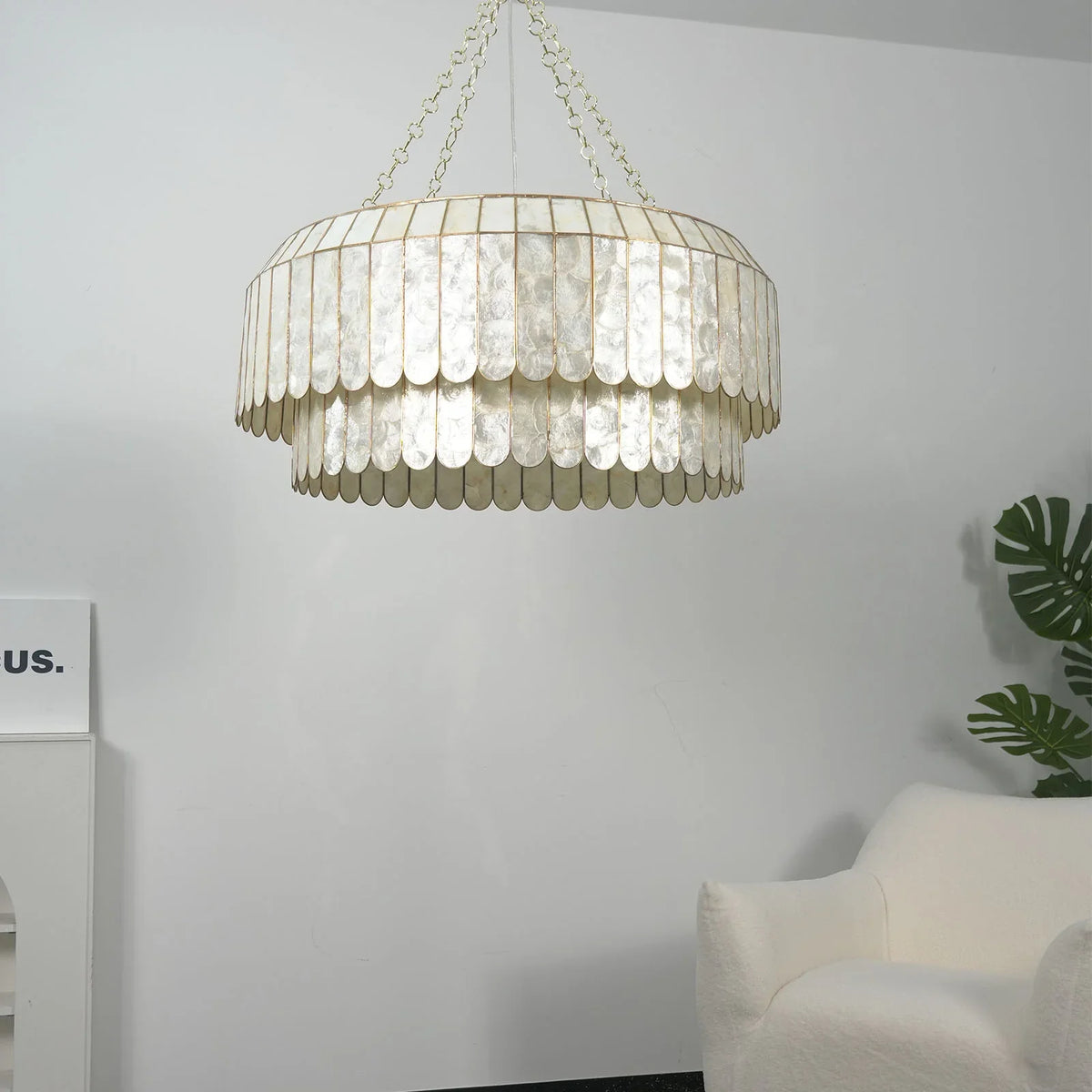 Silver-toned double-tier Light Luxury Shell Chandelier in a minimalist white room