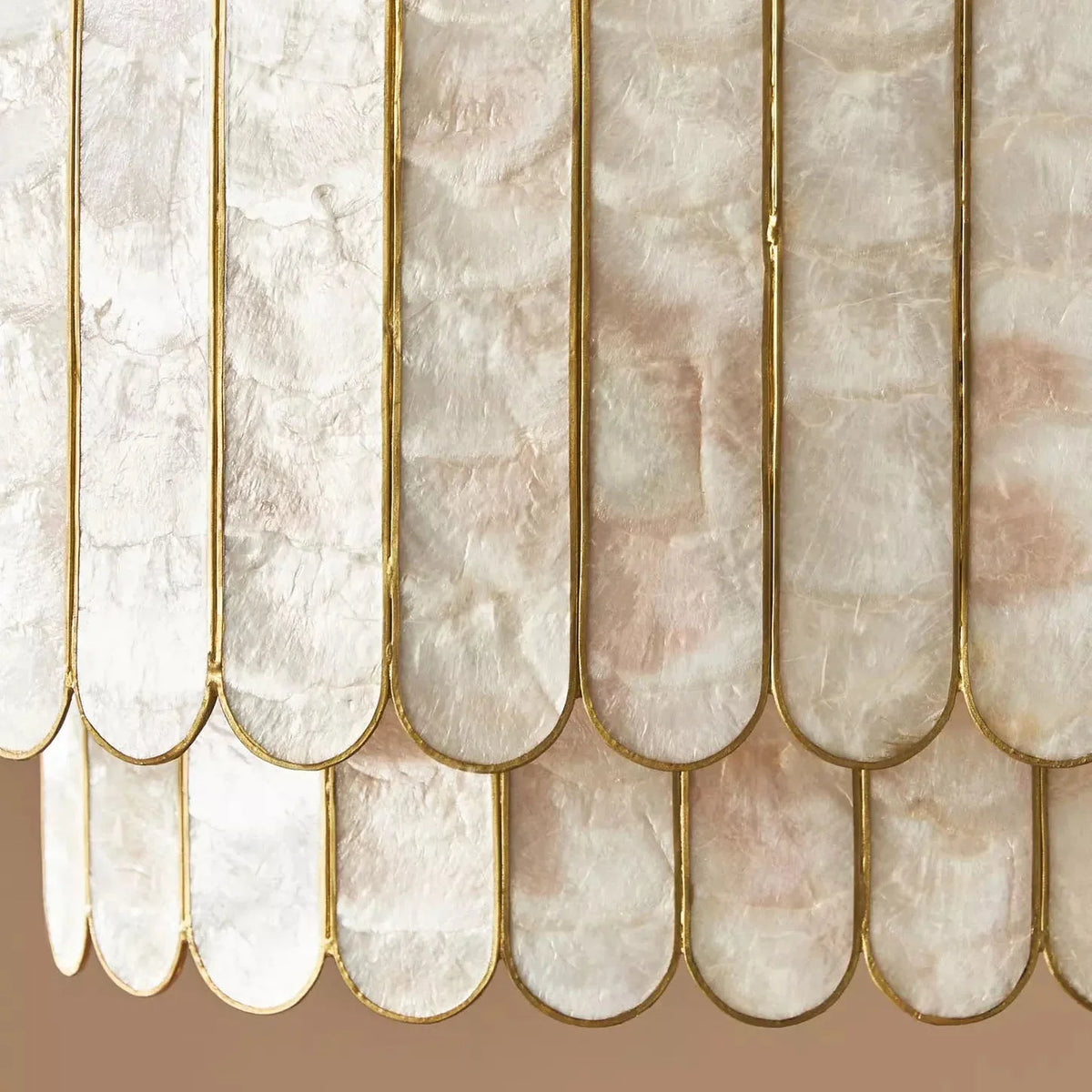 Close-up of silver-toned capiz shells on the chandelier with natural iridescent texture