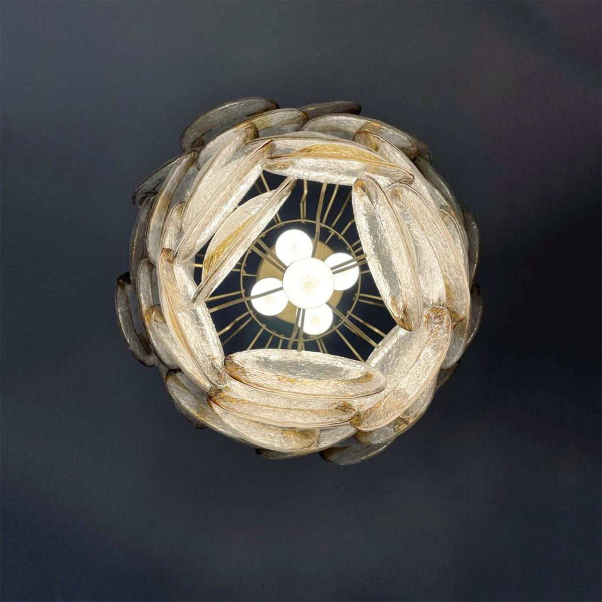 Bottom-up view of the Mazzega-style chandelier, showing the central bulb socket and radiating metal arms.